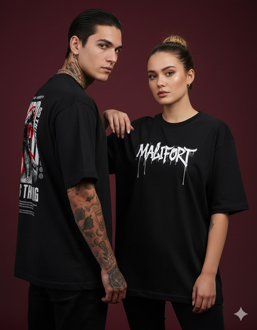 Two people wearing black t-shirts with visible branding against a dark background